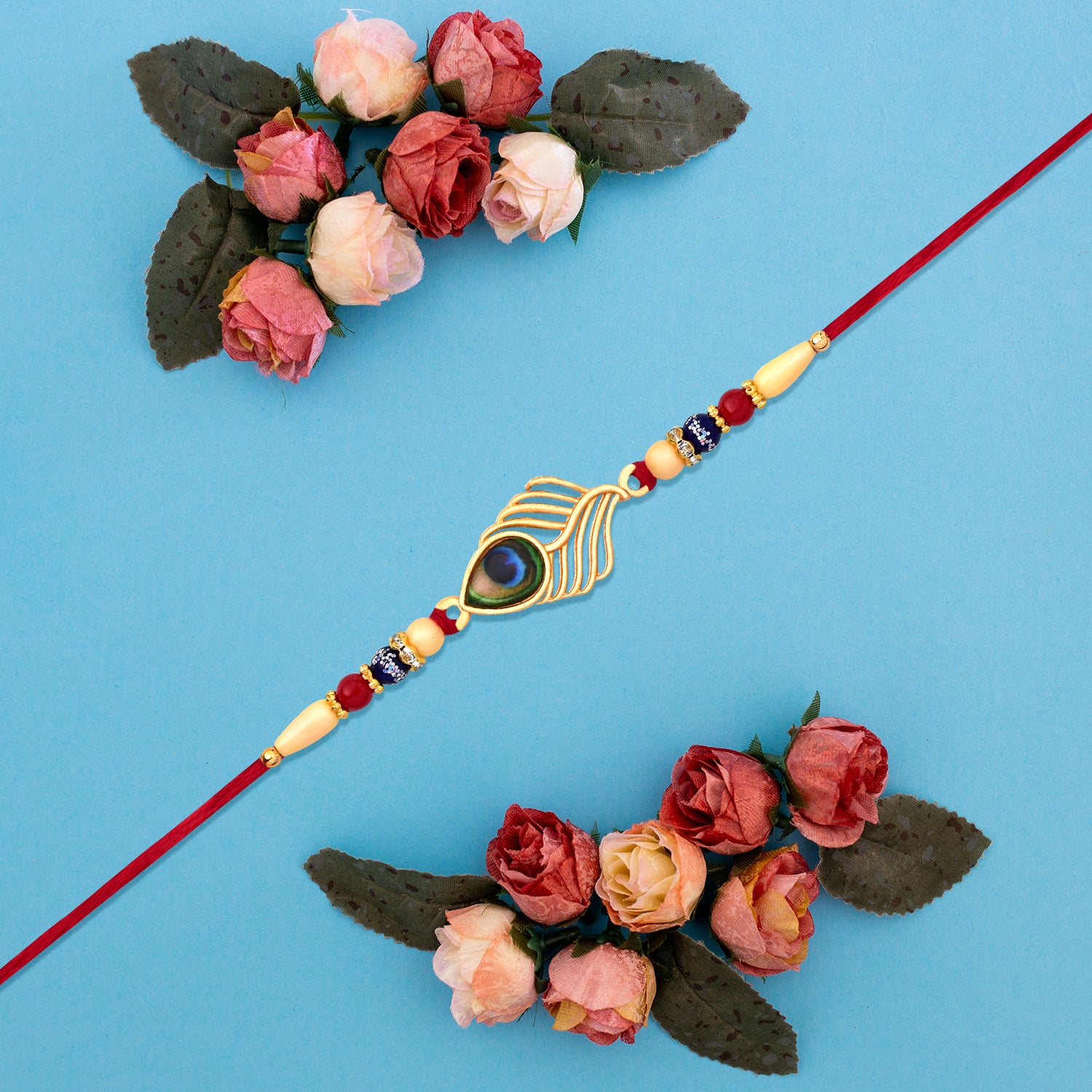 Peacock Feather Design Rakhi With Beaded Detailing And Red Thread Peacock Feather Design Rakhi With Beaded Detailing And Red Thread